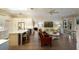 Open kitchen boasts island with seating, stainless steel appliances, and hardwood floors at 3649 Wilderness W Blvd, Parrish, FL 34219