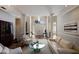 Bright living room with hardwood floors, white sofas, and a fireplace at 3649 Wilderness W Blvd, Parrish, FL 34219