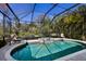 Inviting screened pool and spa with ample lounge space at 3649 Wilderness W Blvd, Parrish, FL 34219