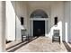 Front porch with two black rocking chairs and double doors at 3649 Wilderness W Blvd, Parrish, FL 34219