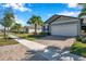 Street view of a row of houses, each with a garage and landscaping at 3747 Laughing Dove Ave, Sun City Center, FL 33573