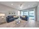 Relaxing living room with blue sofas and a glass coffee table at 3747 Laughing Dove Ave, Sun City Center, FL 33573