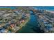 Waterfront property showcases a private pool and boat dock with lush landscaping in this stunning aerial perspective at 400 N Washington Dr, Sarasota, FL 34236