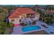 Expansive backyard with a pool, waterfall, and an outdoor dining area at 400 N Washington Dr, Sarasota, FL 34236