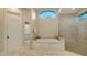 Bathroom with a soaking tub, walk-in shower, and a linen closet, with natural light at 400 N Washington Dr, Sarasota, FL 34236