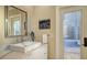Bathroom features a white vanity with quartz countertop, a large mirror, and outdoor access at 400 N Washington Dr, Sarasota, FL 34236