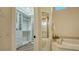Bathroom with a soaking tub, walk-in closet, and views into the dual vanity area at 400 N Washington Dr, Sarasota, FL 34236