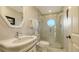 Stylish bathroom featuring a modern vanity, round window in shower, and elegant fixtures at 400 N Washington Dr, Sarasota, FL 34236