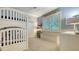 Cozy bedroom with a white bunk bed, blue walls, and natural light from shuttered windows at 400 N Washington Dr, Sarasota, FL 34236