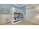 Charming bedroom with a white bunk bed, blue bedding, and coastal decor at 400 N Washington Dr, Sarasota, FL 34236