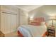 Comfortable bedroom with white bedding, stylish headboard and nightstand, and warm colors at 400 N Washington Dr, Sarasota, FL 34236