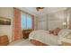 Comfortable bedroom with white bedding, stylish curtains, and a window with lots of natural light at 400 N Washington Dr, Sarasota, FL 34236