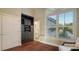 Bonus room with dark hardwood floors, plantation shutters, and built-in entertainment center at 400 N Washington Dr, Sarasota, FL 34236