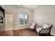 Bonus room with dark hardwood floors, plantation shutters, and sitting area at 400 N Washington Dr, Sarasota, FL 34236