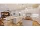 Bright kitchen with a large island, white cabinetry and views to the living room at 400 N Washington Dr, Sarasota, FL 34236