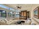 Bright living room featuring stylish furnishings, large windows offering scenic waterfront views, and access to the patio at 400 N Washington Dr, Sarasota, FL 34236