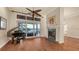 Living room with a fireplace, piano and access to the waterfront lanai at 400 N Washington Dr, Sarasota, FL 34236