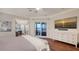 Bright main bedroom boasts a balcony, ensuite office and a mounted TV over a white dresser at 400 N Washington Dr, Sarasota, FL 34236