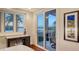 Ensuite office features a desk, cabinetry, and a glass door that leads to the patio at 400 N Washington Dr, Sarasota, FL 34236