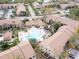 Community pool and surrounding buildings in an aerial view at 4001 Crockers Lake Blvd # 11, Sarasota, FL 34238