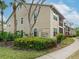 Tan building exterior with lush landscaping and walkways at 4001 Crockers Lake Blvd # 11, Sarasota, FL 34238