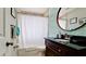 Clean bathroom with tub shower, granite vanity, and tropical-themed wallpaper at 4010 18Th W Ave, Bradenton, FL 34205