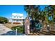 Gated entrance to a property featuring a charming blue house at 4010 18Th W Ave, Bradenton, FL 34205
