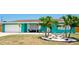 Charming teal home with white trim, landscaping, and a two-car garage at 4010 18Th W Ave, Bradenton, FL 34205