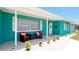 Front porch with teal exterior, white shutters, and two wicker chairs at 4010 18Th W Ave, Bradenton, FL 34205