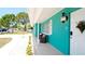 Welcoming front yard with teal house and landscaping at 4010 18Th W Ave, Bradenton, FL 34205