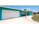 Teal house with white garage door and landscaping at 4010 18Th W Ave, Bradenton, FL 34205