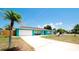 Teal house with white garage door and palm trees at 4010 18Th W Ave, Bradenton, FL 34205