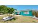 Teal house with white garage door and landscaping at 4010 18Th W Ave, Bradenton, FL 34205
