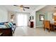 Living room with blue sofa, and view into dining area and kitchen at 4010 18Th W Ave, Bradenton, FL 34205
