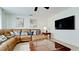 Living area with sectional sofa, coffee table, and large screen TV at 4010 18Th W Ave, Bradenton, FL 34205