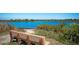 Park bench overlooking a calm body of water, serene nature scene at 4010 18Th W Ave, Bradenton, FL 34205