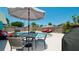 Outdoor patio with table, chairs, umbrella, and grill at 4010 18Th W Ave, Bradenton, FL 34205