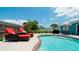 Relaxing pool area with lounge chairs and patio furniture at 4010 18Th W Ave, Bradenton, FL 34205