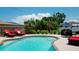 Inviting kidney shaped pool with patio furniture at 4010 18Th W Ave, Bradenton, FL 34205