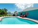 Inviting kidney-shaped pool with brick coping and lounge chairs at 4010 18Th W Ave, Bradenton, FL 34205