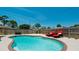 Private pool and patio with brick border and lounge chairs at 4010 18Th W Ave, Bradenton, FL 34205