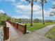 Wooden footbridge over water with walkway, leading to a serene lake view at 4049 Crockers Lake Blvd # 23, Sarasota, FL 34238