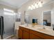Double vanity bathroom with a shower and linen closet at 4153 Lenox Blvd, Venice, FL 34293
