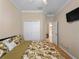 Spacious bedroom with leafy bedding, ceiling fan, and double doors to closet at 4153 Lenox Blvd, Venice, FL 34293