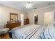 Main bedroom with dresser and closet, featuring patterned bedding at 4153 Lenox Blvd, Venice, FL 34293