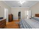 Bright bedroom with wood floors, walk-in closet, and dresser at 4153 Lenox Blvd, Venice, FL 34293