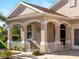 Front porch with arched entryway and white railings at 4153 Lenox Blvd, Venice, FL 34293