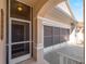 Front entry with a screen door and attached garage at 4153 Lenox Blvd, Venice, FL 34293