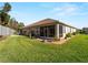 Back exterior view of house with screened patio and garden at 4153 Lenox Blvd, Venice, FL 34293