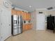 Bright kitchen with stainless steel refrigerator and ample wood cabinetry at 4153 Lenox Blvd, Venice, FL 34293